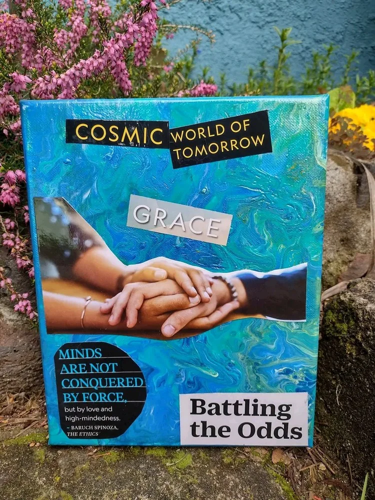 Canvas in swirling turquoise and blue. Several hands rest on top of one another beneath the word Grace. Other pieces read Cosmic world of tomorrow and Battling the odds, with a Baruch Spinoza line saying minds are conquered by love and high-mindedness, not force.